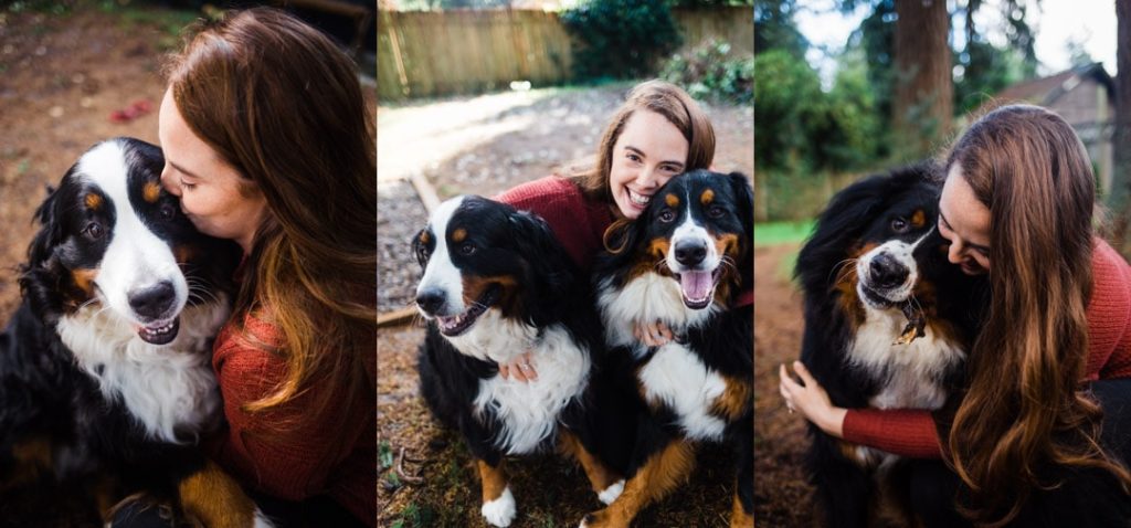 woman kissing and hugging 2 bernese mountain dogs
