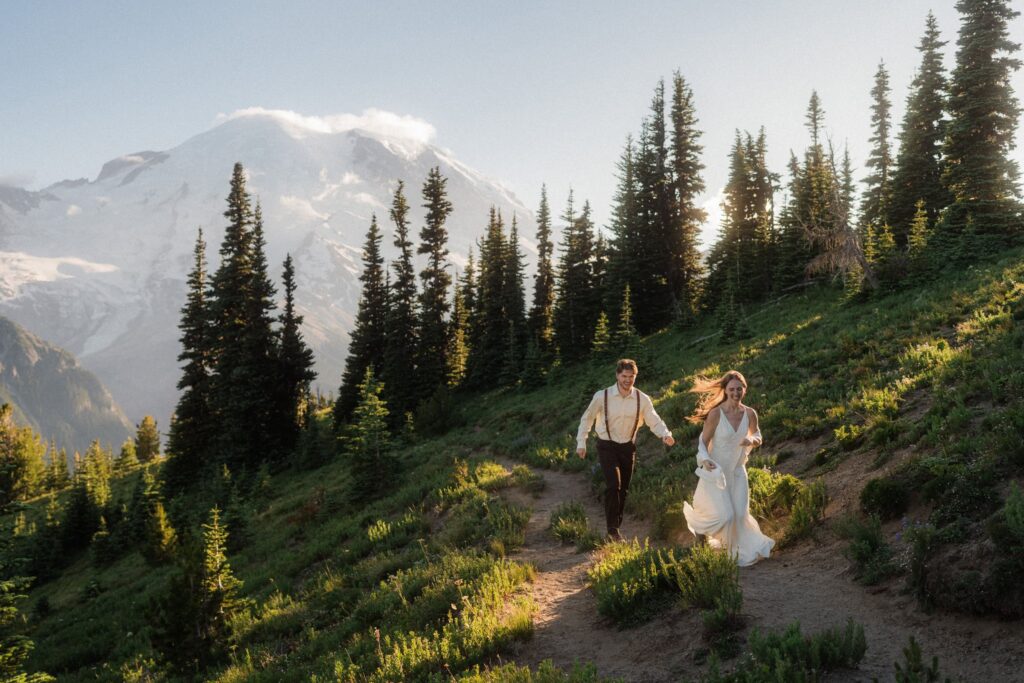 A couple frolicking on a trail during their Mount Rainier Elopement.