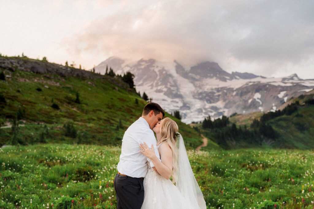 couple kissing at sunset during their mt. rainier wildflower elopement