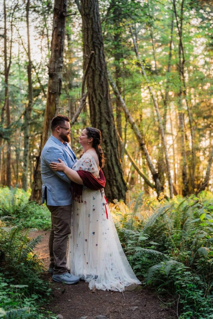 a couple embracing each other in the golden trees of their elopement hike on Orcas Island