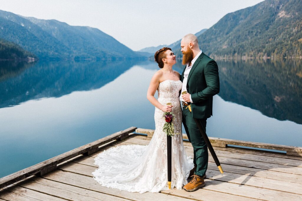 eloping couple gazing into each others eyes with prop Viking swords for Lake Crescent Elopement