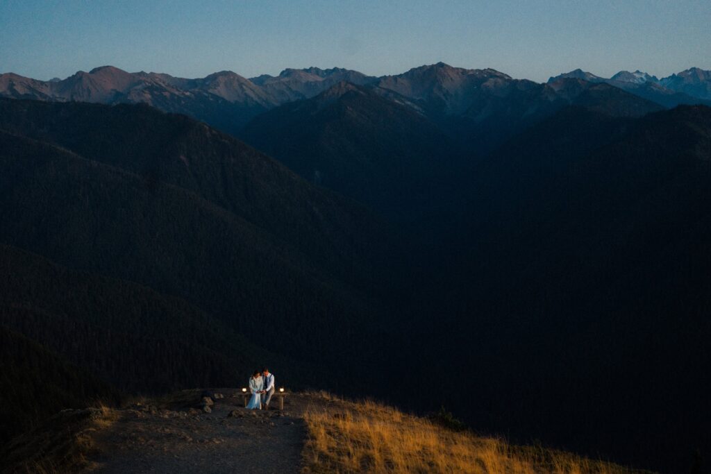 a couple sitting quietly amongst the grand mountains of the Olympics during their Olympic National Park Elopement.