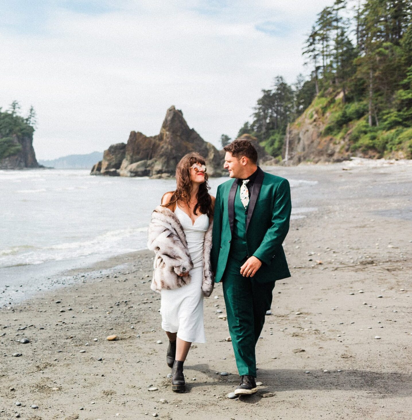 couple walking on washington coast after their elopement