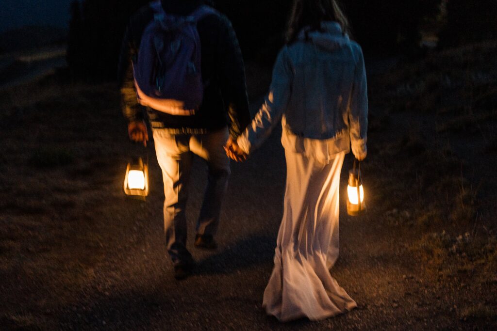 a couple holding lanterns during their elopement.