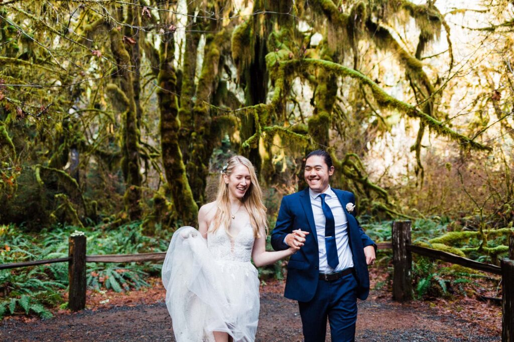 bride and groom running in the hall of mosses holding hands
