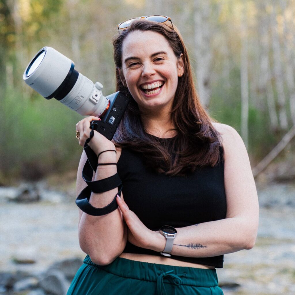 Photographer posing with camera in the wilderness