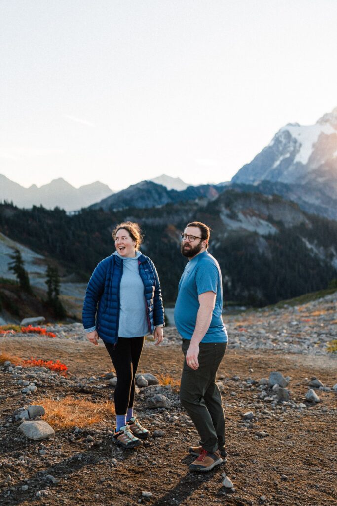 a couple beaming at the sunrise on their North Cascades Hiking Elopement